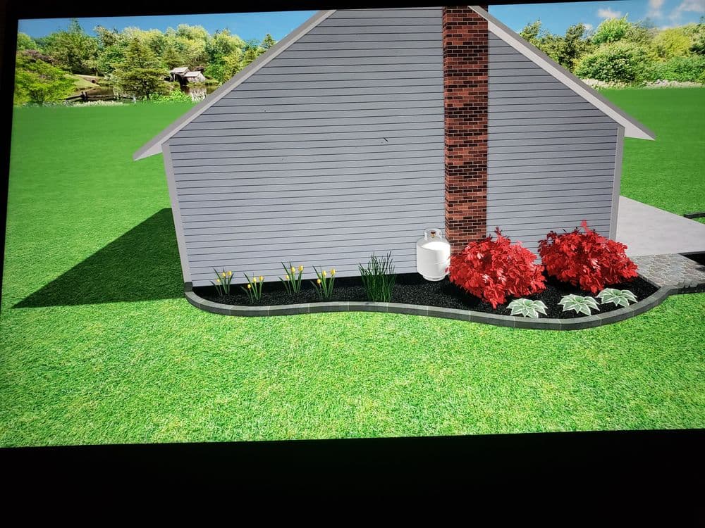 Landscape design featuring a home with a brick chimney, colorful flowers, and green lawn.