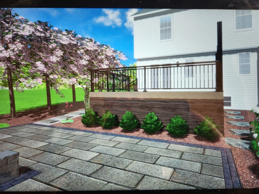 Modern backyard design featuring a wooden deck, landscaped garden, and blooming cherry trees.