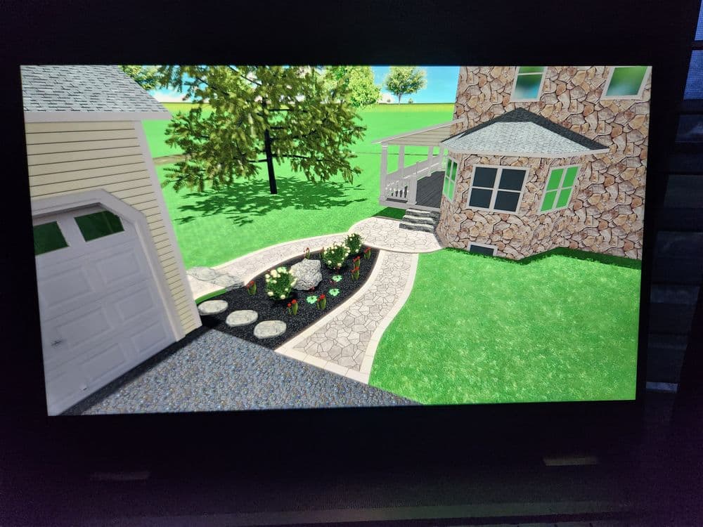 3D landscape design featuring a stone house, garage, and flower garden pathway.