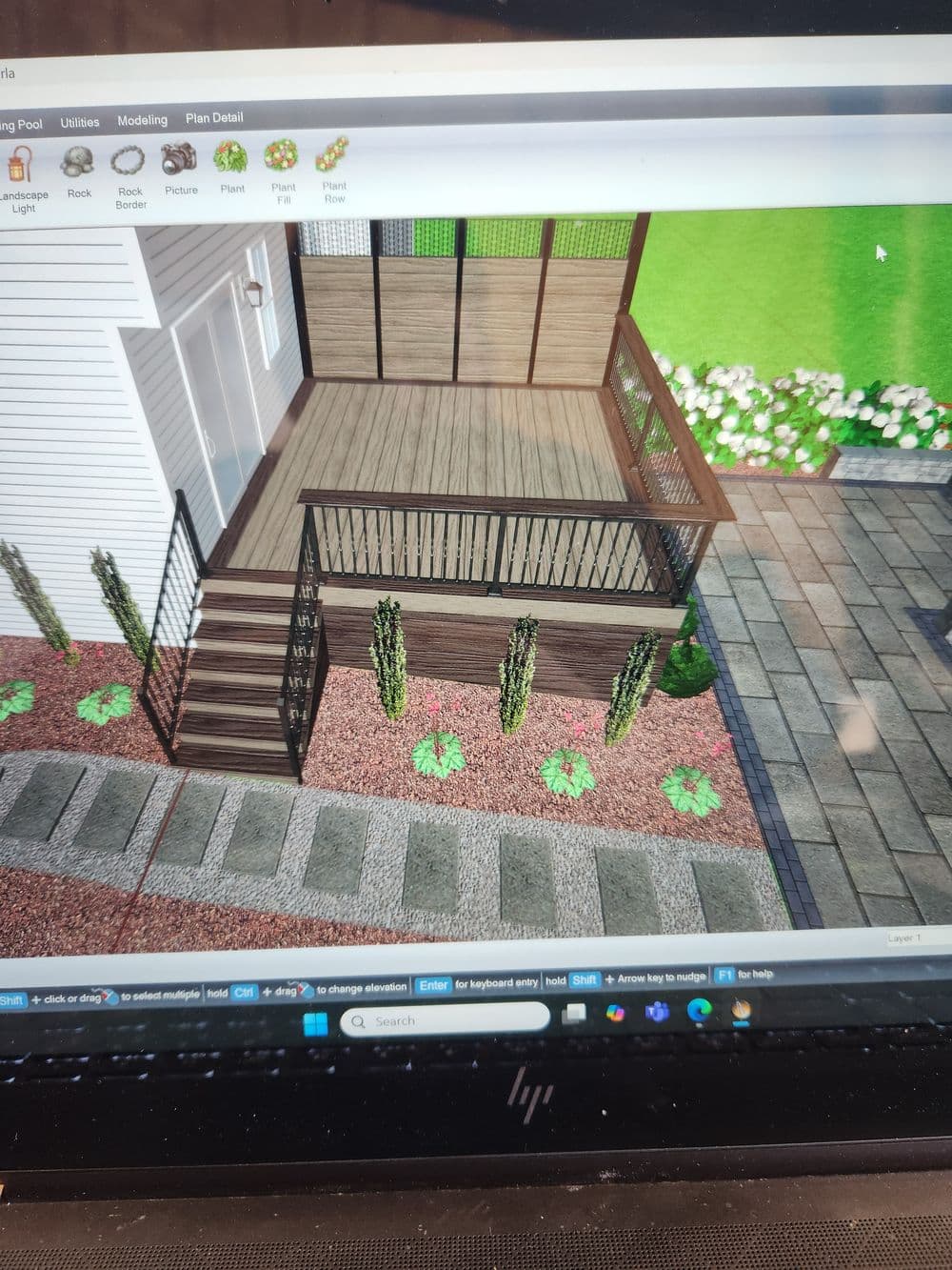 3D rendering of a modern deck with planters and landscaping design details.