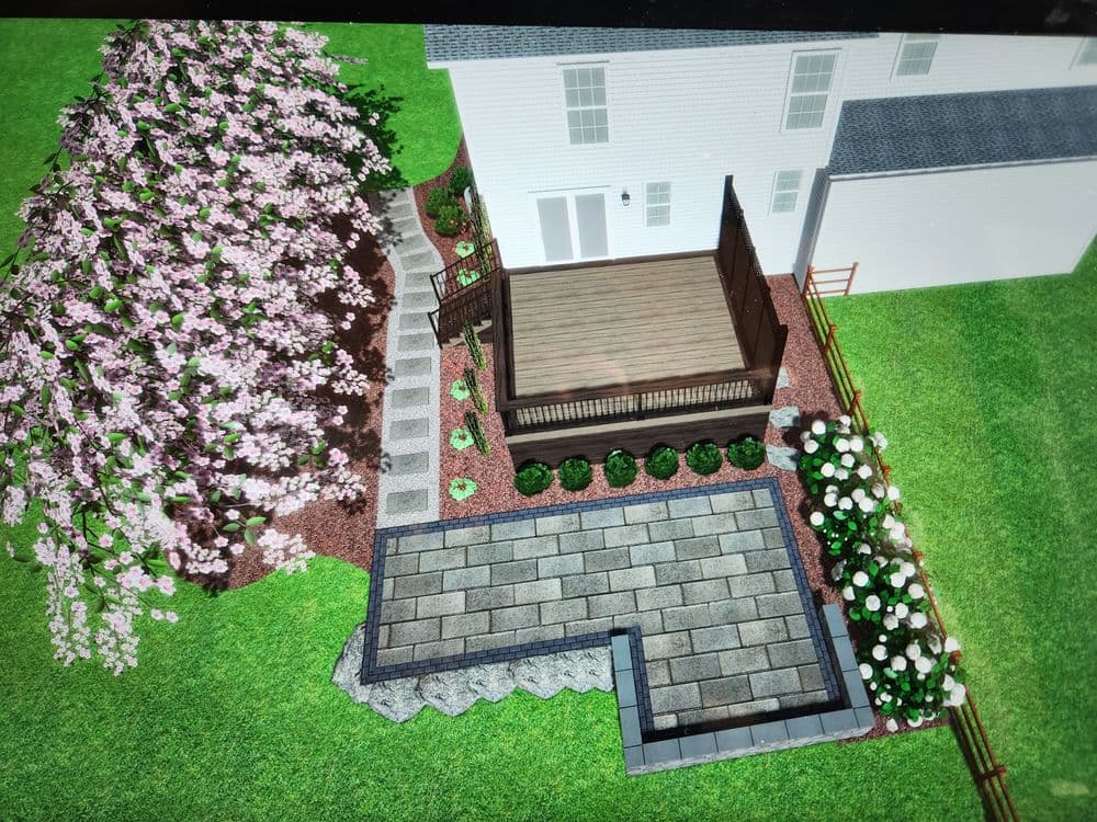 3D rendering of a landscaped backyard featuring a wooden deck, paving stones, and flowering plants.